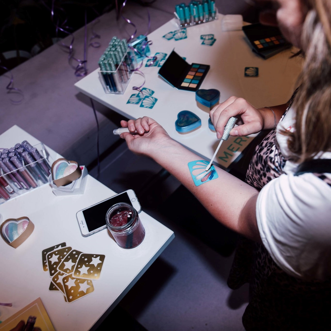 Custom makeup swatch stencil in use at a product launch influencer event